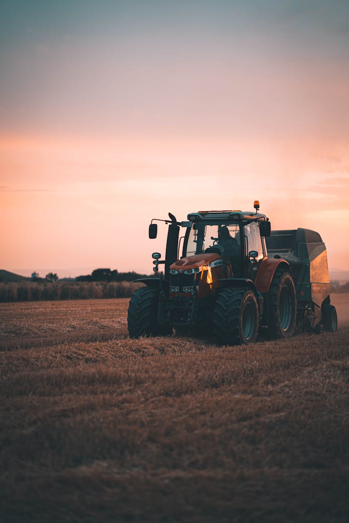 services-02 Tractor working in a Wiesbaden field during a picturesque sunset with ample copy space.